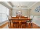 Traditional dining room featuring hardwood floors, chandelier, and large window for natural light at 3005 Streamlet Way, Monroe, NC 28110