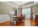 Dining room featuring hardwood floors, wainscoting, chandelier, and large window for natural light at 3005 Streamlet Way, Monroe, NC 28110