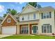 Charming two-story home featuring stone accents, a two-car garage, and a welcoming front porch at 3005 Streamlet Way, Monroe, NC 28110