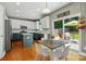 Contemporary kitchen featuring white cabinets, stainless appliances, an island, and a dining area at 3005 Streamlet Way, Monroe, NC 28110