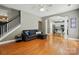 Cozy living room with hardwood floors, access to a kitchen, and staircase to the upper floor at 3005 Streamlet Way, Monroe, NC 28110