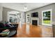 Bright living room featuring a fireplace, hardwood floors, and an open layout to the kitchen at 3005 Streamlet Way, Monroe, NC 28110