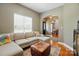 Cozy living room featuring a sectional sofa, ottoman, and hardwood floors at 3005 Streamlet Way, Monroe, NC 28110