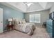 Serene main bedroom with a tray ceiling, complemented by a bed and neutral tones for relaxation at 3005 Streamlet Way, Monroe, NC 28110