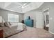 Spacious main bedroom showcasing a bed, tray ceiling, dresser, and tranquil ambiance at 3005 Streamlet Way, Monroe, NC 28110