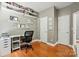 Bright office with floating shelves, desk, and hardwood floors, creating a perfect workspace at 3005 Streamlet Way, Monroe, NC 28110