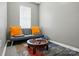 Inviting sitting area featuring a futon with vibrant pillows, a round coffee table, and a patterned rug at 3005 Streamlet Way, Monroe, NC 28110