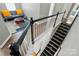 Stylish staircase with decorative railing, complemented by hardwood floors and a glimpse of the living space at 3005 Streamlet Way, Monroe, NC 28110