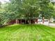 Expansive backyard with a well-manicured lawn, mature trees, a patio, and an attached garage at 3158 Salisbury Hwy, Statesville, NC 28677