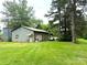 A large barn sits on a sprawling green lawn dotted with mature trees, with vehicles parked alongside at 3158 Salisbury Hwy, Statesville, NC 28677