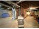Unfinished basement featuring a brick fireplace, wood burning stove, and exposed ductwork at 3158 Salisbury Hwy, Statesville, NC 28677