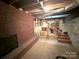 Unfinished basement with a brick fireplace and access to the stairs, laundry and other rooms at 3158 Salisbury Hwy, Statesville, NC 28677
