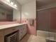 Compact pink bathroom featuring a large mirror, vanity, and a tub/shower combination at 3158 Salisbury Hwy, Statesville, NC 28677