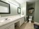 Bright bathroom with a double sink vanity, granite countertop, and two decorative mirrors at 3158 Salisbury Hwy, Statesville, NC 28677