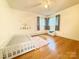 Bright bedroom featuring natural light, wood floors, and playful decor, creating a cheerful atmosphere at 3158 Salisbury Hwy, Statesville, NC 28677