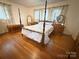 Bedroom showcasing a four-poster bed, hardwood floors, and lots of natural light at 3158 Salisbury Hwy, Statesville, NC 28677