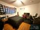 Cozy bedroom featuring a comfortable bed, wooden floors, and a desk setup for work or study at 3158 Salisbury Hwy, Statesville, NC 28677