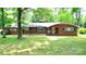 Charming single-story brick home with a well-manicured lawn and mature trees, inviting curb appeal at 3158 Salisbury Hwy, Statesville, NC 28677