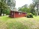 Exterior view of a brick home, surrounded by a lush green lawn and mature trees at 3158 Salisbury Hwy, Statesville, NC 28677