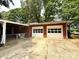 Attached two-car garage with an outdoor patio area and a well-manicured lawn at 3158 Salisbury Hwy, Statesville, NC 28677