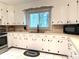 Well-lit kitchen featuring white cabinets, stainless appliances, and a neutral-toned countertop at 3158 Salisbury Hwy, Statesville, NC 28677