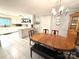 Charming kitchen featuring an island, hanging pot rack, and adjacent dining area with wood table and bench at 3158 Salisbury Hwy, Statesville, NC 28677