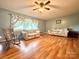 Comfortable living room featuring hardwood floors, large window, and cozy furniture, perfect for relaxation at 3158 Salisbury Hwy, Statesville, NC 28677