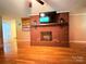 Bright living room with hardwood floors, a brick fireplace, and built-in shelving for storage at 3158 Salisbury Hwy, Statesville, NC 28677