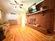 Spacious living room featuring a red brick fireplace, hardwood floors, and comfortable seating at 3158 Salisbury Hwy, Statesville, NC 28677