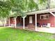 Relaxing covered patio featuring an outdoor dining set, grill, and ample space for entertaining guests at 3158 Salisbury Hwy, Statesville, NC 28677