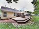 Home's rear exterior featuring a large deck with seating and an umbrella table at 3347 Xandra Ct, Indian Land, SC 29707