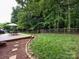 Backyard featuring a deck with outdoor seating, a lush lawn, and a backdrop of mature trees at 3347 Xandra Ct, Indian Land, SC 29707