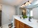 Bathroom with double vanity, wood-look tile floor, and updated light fixture at 3347 Xandra Ct, Indian Land, SC 29707