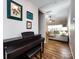 Inviting foyer with hardwood floors, a piano, and living room view at 3347 Xandra Ct, Indian Land, SC 29707