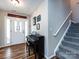 Home foyer with hardwood floors, piano, and stairwell at 3347 Xandra Ct, Indian Land, SC 29707