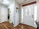 Bright foyer with wood floors and white paneled front door at 3347 Xandra Ct, Indian Land, SC 29707