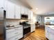 Modern kitchen boasts stainless appliances, granite countertops, and white cabinets at 3347 Xandra Ct, Indian Land, SC 29707