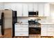 Stylish kitchen features white cabinets, stainless appliances, and granite countertops at 3347 Xandra Ct, Indian Land, SC 29707