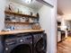 Convenient laundry area with shelving and modern washer/dryer units at 3347 Xandra Ct, Indian Land, SC 29707