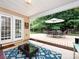 A covered patio with a dining set and a seating area extends from the home into the backyard at 3347 Xandra Ct, Indian Land, SC 29707