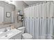 Updated bathroom featuring modern fixtures, a decorative shower curtain, and vanity, offering a clean and stylish space at 3419 Brickyard Ln, Midland, NC 28107