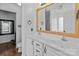 Bathroom featuring a double vanity, wood-framed mirror, and view to adjacent space at 3419 Brickyard Ln, Midland, NC 28107