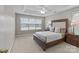 Spacious bedroom features a large window, tray ceiling, and a comfortable bed with upholstered headboard at 3419 Brickyard Ln, Midland, NC 28107