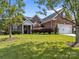 Charming brick home featuring a manicured lawn, attached garage, and inviting front entrance at 3419 Brickyard Ln, Midland, NC 28107