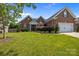 Charming brick home featuring a manicured lawn, attached garage, and inviting front entrance at 3419 Brickyard Ln, Midland, NC 28107