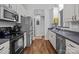 Well-lit kitchen featuring modern appliances, white cabinets and stainless steel dishwasher, and a gray countertop at 3419 Brickyard Ln, Midland, NC 28107