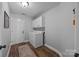 Practical laundry room with washer, dryer, cabinets, and a door to the outside, offering convenience at 3419 Brickyard Ln, Midland, NC 28107