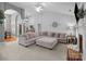 Open-concept living room with a plush sectional sofa, a brick fireplace, and high vaulted ceilings at 3419 Brickyard Ln, Midland, NC 28107