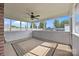 Bright and airy screened patio with ceiling fan and large windows offering a view of the backyard at 3419 Brickyard Ln, Midland, NC 28107