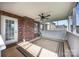 Cozy screened-in patio featuring a brick wall, ceiling fan, and neutral rug, perfect for relaxing outdoors at 3419 Brickyard Ln, Midland, NC 28107